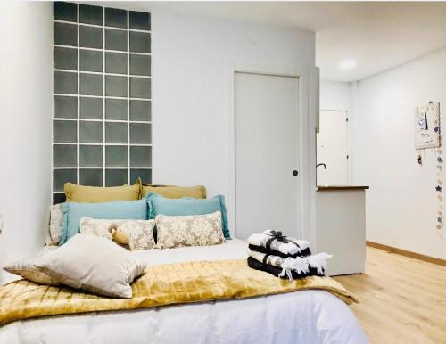 a bedroom with a large bed with a blue headboard at Apartamento in Alicante