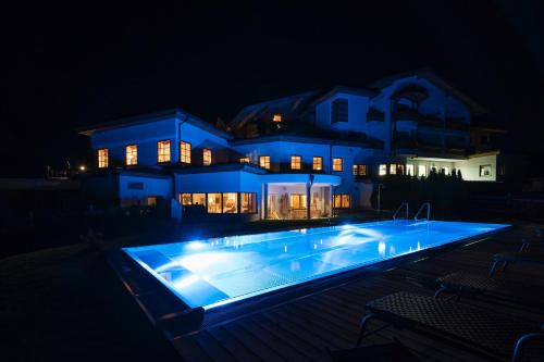 a house with a swimming pool at night at Chalet Winterbauer in Flachau
