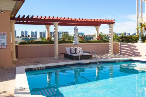a swimming pool with a gazebo and an umbrella at King David Condominium Sunny Isles Beach in Miami Beach