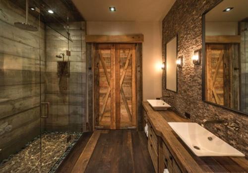 a bathroom with a sink and a glass door at Berghotel Habbel und die Welt kann warten in Cobbenrode
