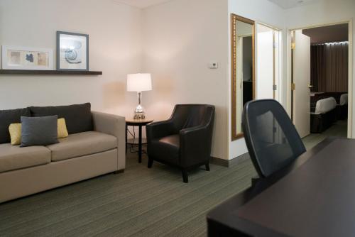 a living room with a couch and a chair at Country Inn & Suites by Radisson, Effingham, IL in Effingham