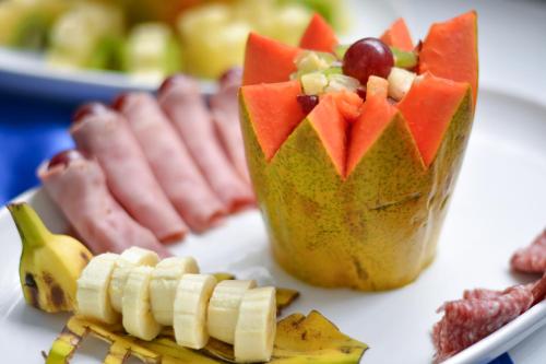 a plate of food with a cup of fruit at Hotel Terra do Sal in Mossoró