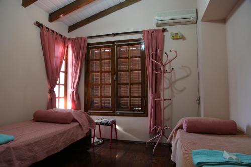 a room with two beds and a window at Espectacular casa in Cordoba
