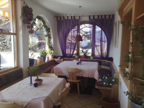 a room with two tables and a window at Garni Reider in Meltina