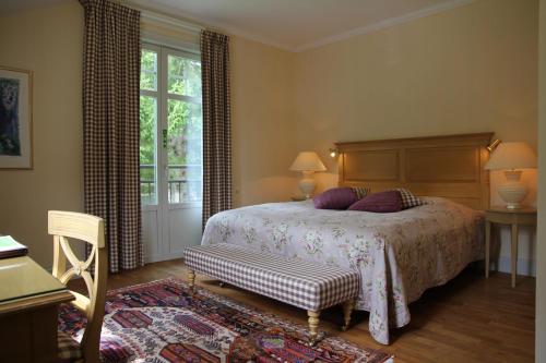 a bedroom with a bed and a table and a window at Hestraviken Hotell & Spa in Hestra