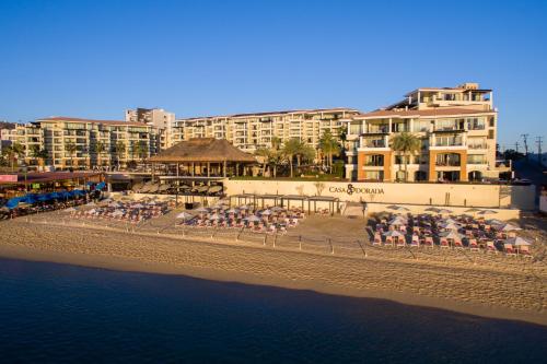 a beach with a group of chairs and umbrellas at Casa Dorada Los Cabos Resort & Spa in Cabo San Lucas