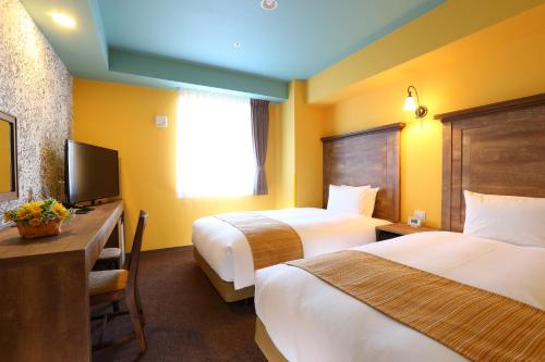 Кровать или кровати в номере Hotel Wing International Select Nagoya Sakae