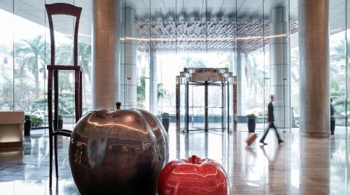 a vase and an apple on display in a building at Pullman Hanoi in Hanoi