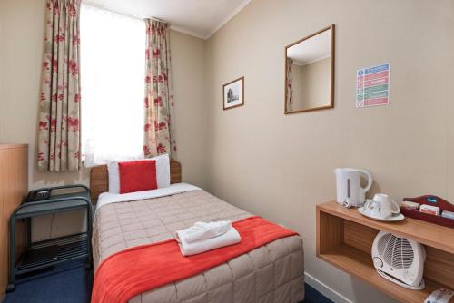 a hotel room with a bed and a window at Halswell Lodge in Wellington
