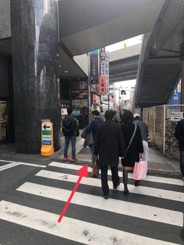 a group of people walking down a street at GreenHotel in Tokyo