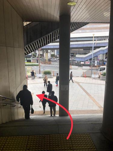 a group of people walking in a building with a red ribbon at GreenHotel in Tokyo