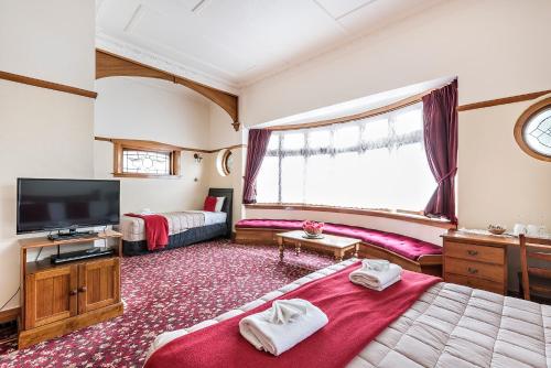 a bedroom with a bed and a tv in a room at Halswell Lodge in Wellington