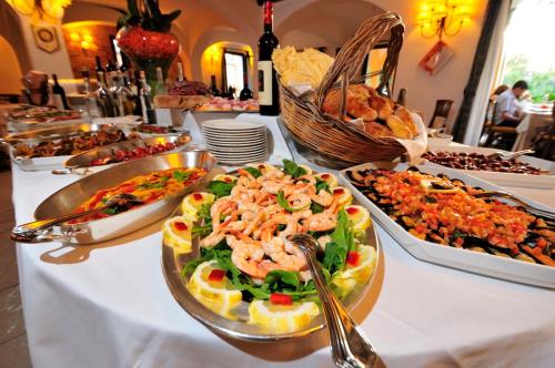 a table with many different dishes of food on it at Hotel Arbatasar in Àrbatax