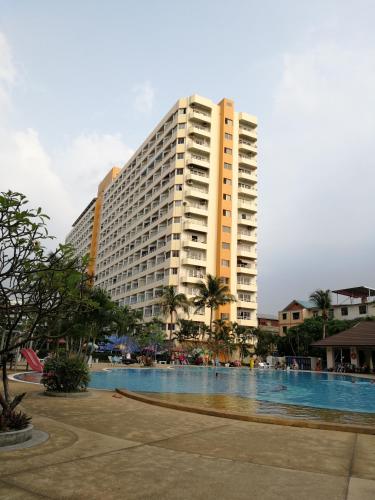 a tall building with a swimming pool in front of it at View Talay 1B by Fernando in Pattaya South