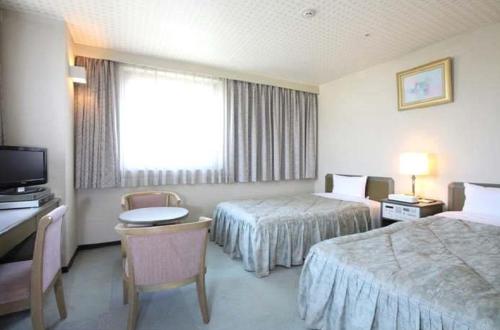 Un pat sau paturi într-o cameră la Pulses Inn Kyoto