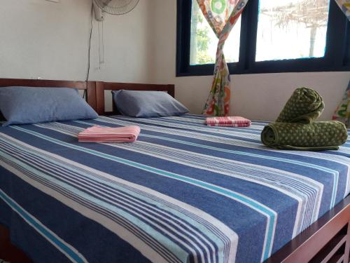 Postel nebo postele na pokoji v ubytování Sayuri Beach Hotel