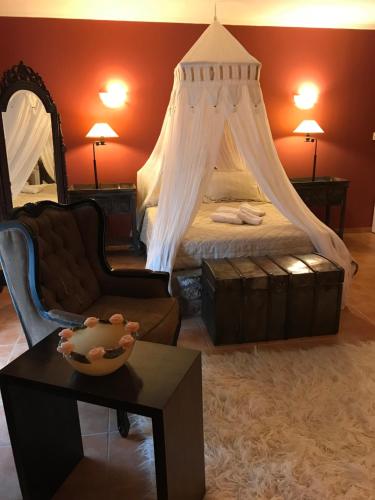 a bedroom with a bed with a canopy at Aloni Toy Kir Thanasi Hotel & Spa in Volakas