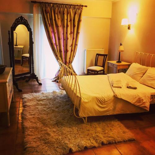 a bedroom with a bed and a rug at Aloni Toy Kir Thanasi Hotel & Spa in Volakas