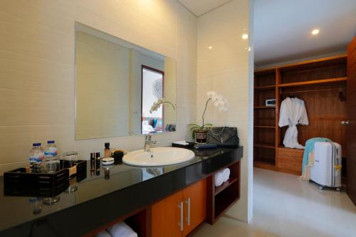 a bathroom with a sink and a mirror at Vansari Serenity Villa in Seminyak