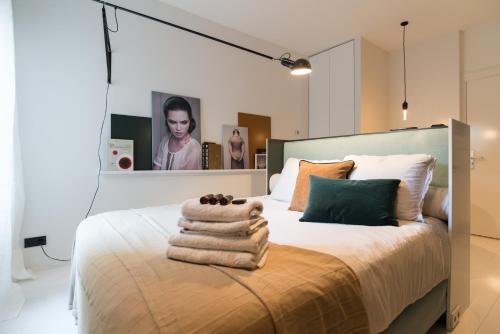 a bedroom with a bed with towels on it at Canal Suite City Centre in Amsterdam