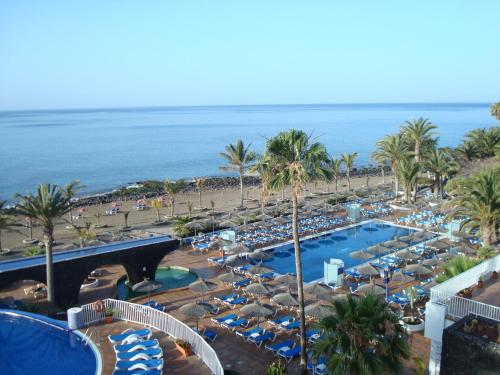 a view of a resort with a beach and a pool at VIK Hotel San Antonio in Puerto del Carmen