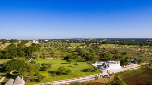 an aerial view of a park with trees and buildings at Trullo la Quiete in Alberobello