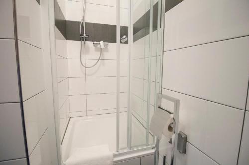 a bathroom with a shower with a glass door at Narodni Stay in Prague