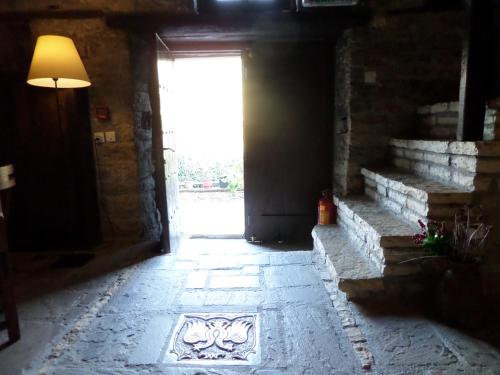 an empty hallway with a door and a window at Arhontiko Aristis in Aristi