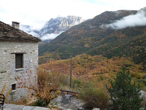 a stone building with a view of a mountain at Arhontiko Aristis in Aristi