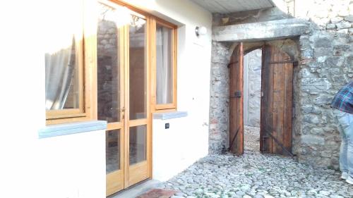 an entrance to a house with a wooden door at La Casa delle Fate in Solto Collina