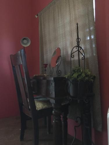 a room with a table and a chair and a mirror at 自然海naturalhigh in Dahan