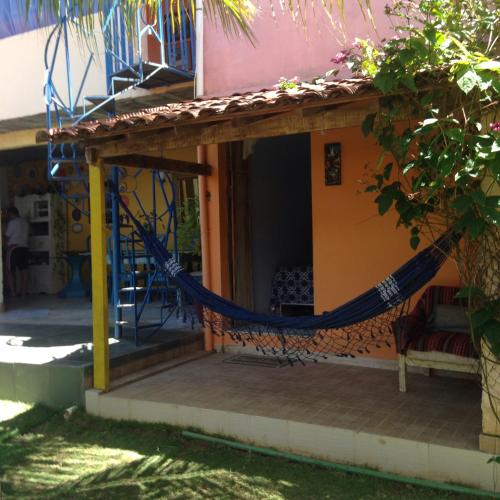 a hammock on the porch of a house at Pousada Peregrino in Barra de Jacuípe