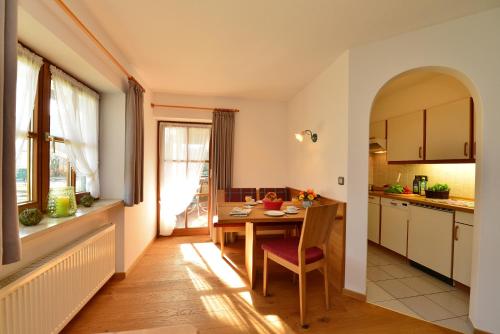 a kitchen and dining room with a table and a window at Haus Am Mühlenweg in Oberstdorf