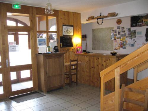 a classroom with a bar and a chalkboard on the wall at HOTEL Auberge du grand Git in La Chaux Neuve