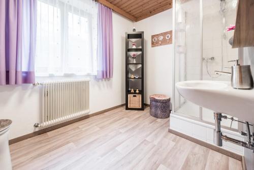 a bathroom with a sink and a tub and a sink at Apartment Haus Gold in Fusch an der Glocknerstraße