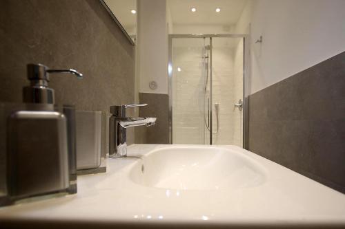 a bathroom with a white tub and a shower at SAHI - Residenza Bianca di Savoia in Milan