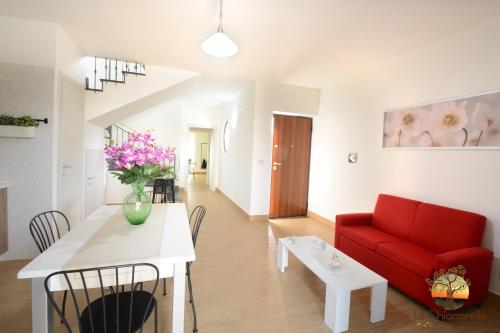 a living room with a red couch and a table at La Chianarella in Ascea