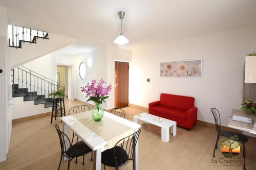 a living room with a red couch and a table at La Chianarella in Ascea