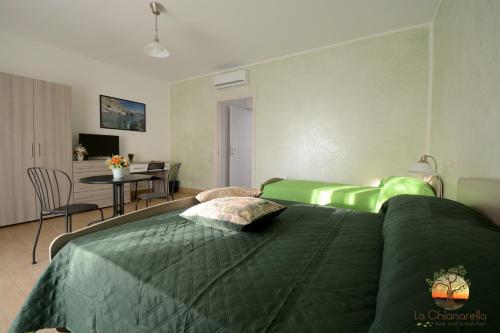 a bedroom with two green beds and a table at La Chianarella in Ascea
