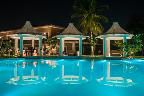 a resort with a swimming pool at night at Swosti Chilika Resort in Kānāipur