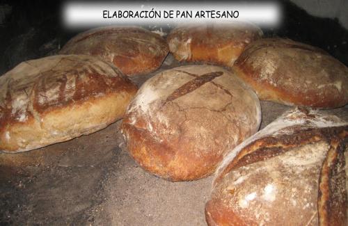 a group of loaves of bread sitting on a tray at Albergue Areitz Soroa in Arce