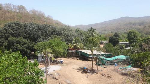 a view of a village with trees and a mountain at Shreyas Guest house - Tatkare Villa in Kashid