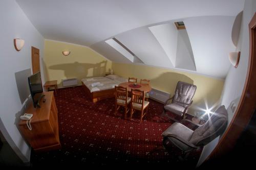 a room with a bed and a table and chairs at ČS RoBiN OIL Harrachov in Harrachov