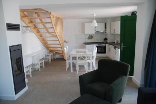 a kitchen and dining room with a table and chairs at Remise am Schlosspark in Schwielowsee