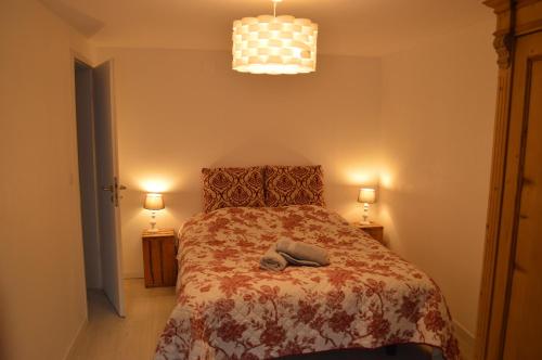 a bedroom with a bed with a robe on it at Coeur d'Alsace 3 in Kaysersberg