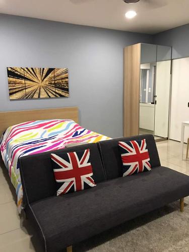 a bedroom with a bed with british flag pillows at 34 Studio at Trefoil Setia Alam in Shah Alam