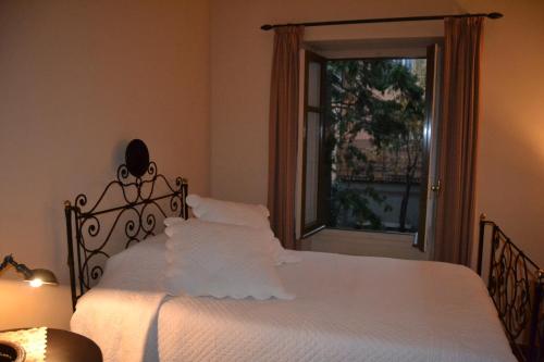 a bedroom with a white bed with a window at Albergo Residence Perosi in Tortona