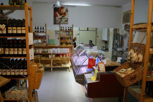 a store filled with lots of bottles of wine at Valli Unite in Costa Vescovato