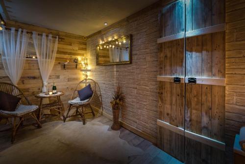 a room with wooden walls and a table and chairs at Vila House Family in Poprad
