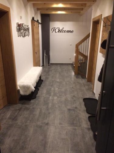 a room with a hallway with a staircase and a white couch at Ferienhaus Wind in Sankt Margarethen im Lungau